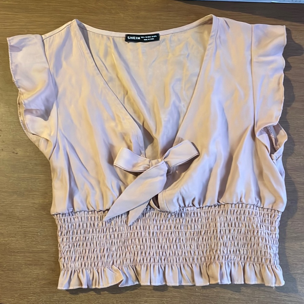 Beautiful rose nude colored top, very cute but runs small. It did not fit me.